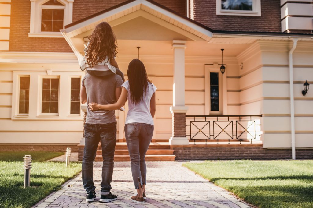 Family Looking at House Exterior