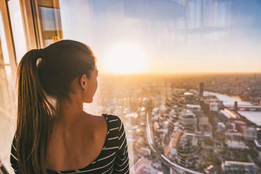 Woman in Condo Overlooking Neighbourhoods